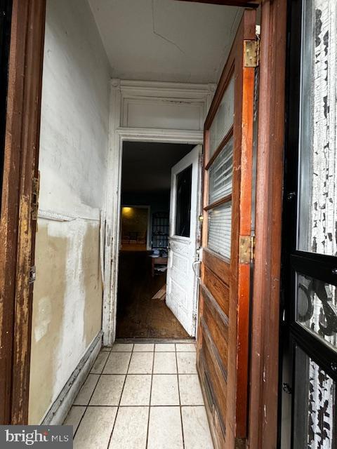 corridor featuring light tile patterned floors