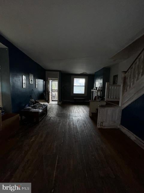 unfurnished living room featuring dark wood-type flooring