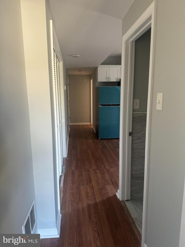 corridor featuring dark hardwood / wood-style floors