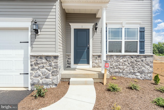 view of exterior entry with a garage