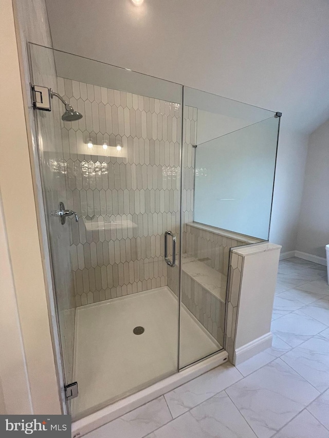 bathroom with a shower with door