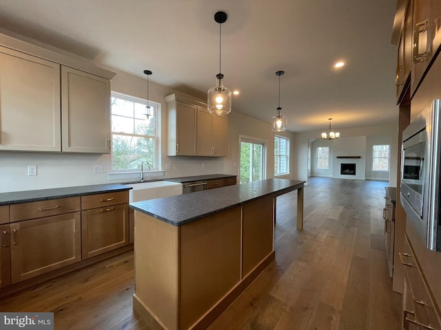 kitchen with a center island, dark hardwood / wood-style flooring, a healthy amount of sunlight, and sink