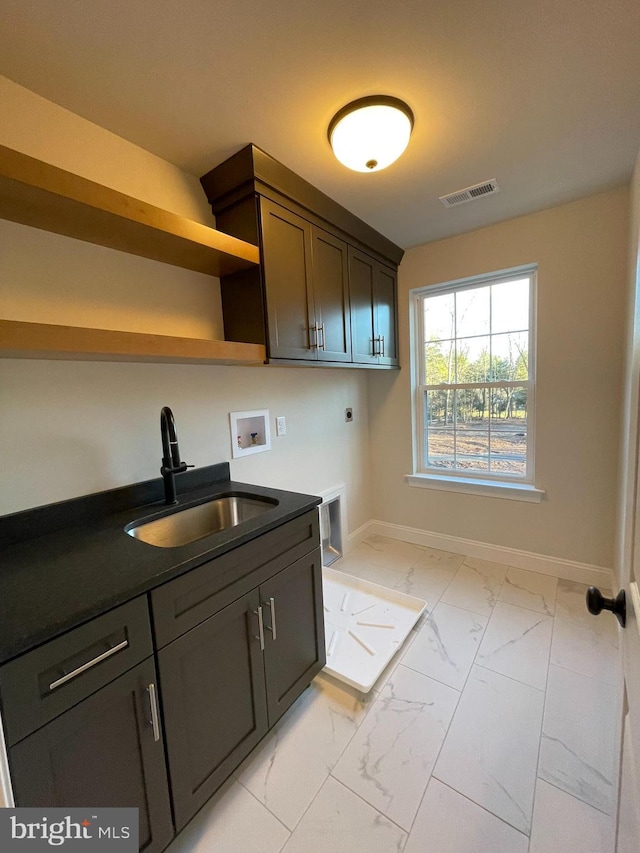 kitchen featuring sink and dark brown cabinets