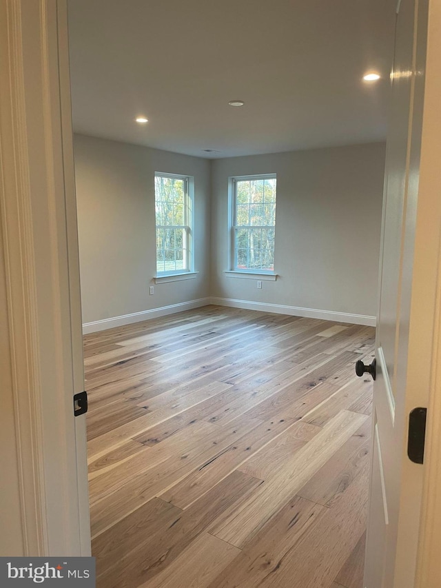 empty room with light hardwood / wood-style flooring