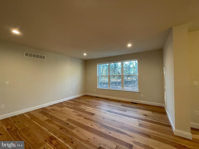 unfurnished room with light hardwood / wood-style floors