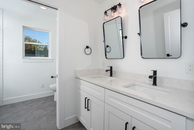 bathroom featuring tile patterned floors, vanity, and toilet