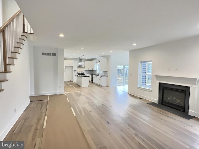 unfurnished living room featuring light hardwood / wood-style flooring