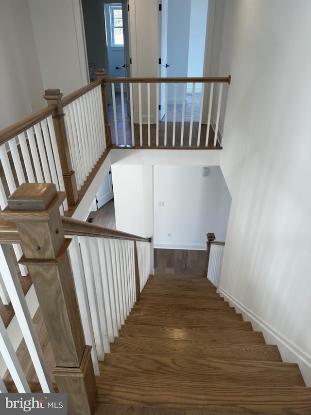 stairway with hardwood / wood-style floors