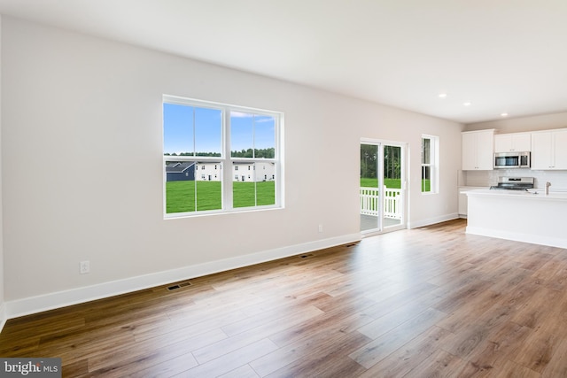 unfurnished living room featuring light wood-type flooring