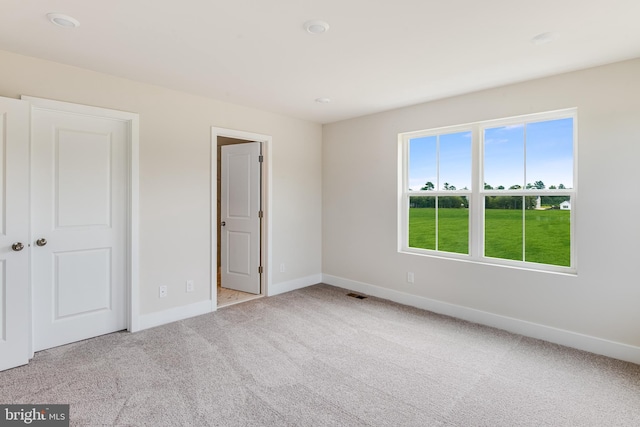 unfurnished bedroom with light colored carpet