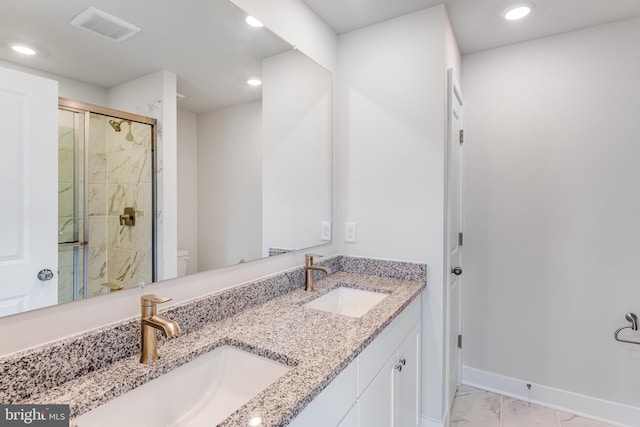 bathroom featuring vanity, toilet, and a shower with door