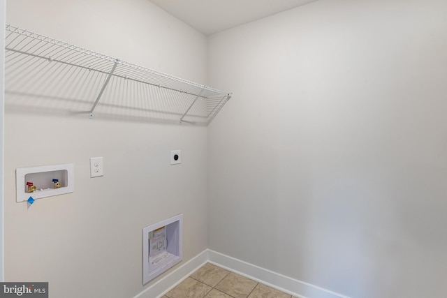 laundry area featuring hookup for an electric dryer, washer hookup, and light tile patterned floors