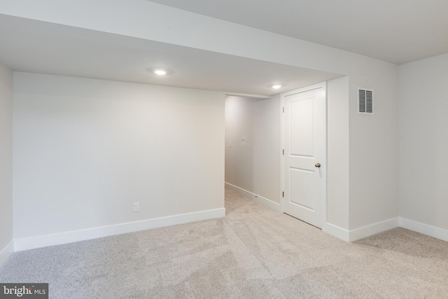 basement featuring light carpet