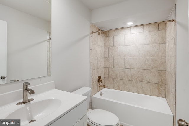 full bathroom featuring vanity, toilet, and tiled shower / bath