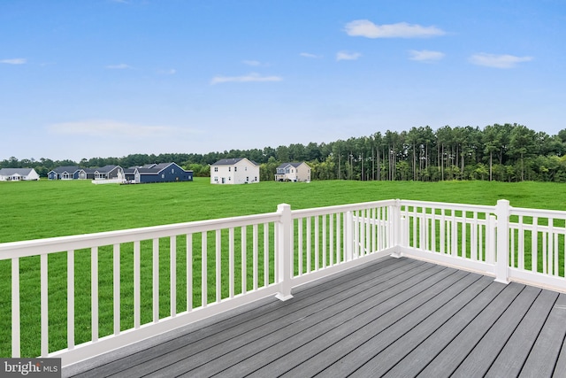 wooden terrace featuring a yard