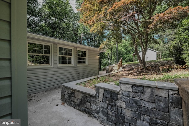 view of patio featuring a shed