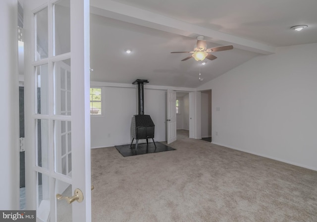 interior space featuring vaulted ceiling with beams, light carpet, and ceiling fan