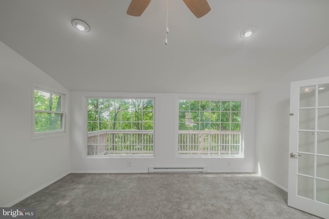 empty room featuring a baseboard radiator, vaulted ceiling, ceiling fan, and light colored carpet