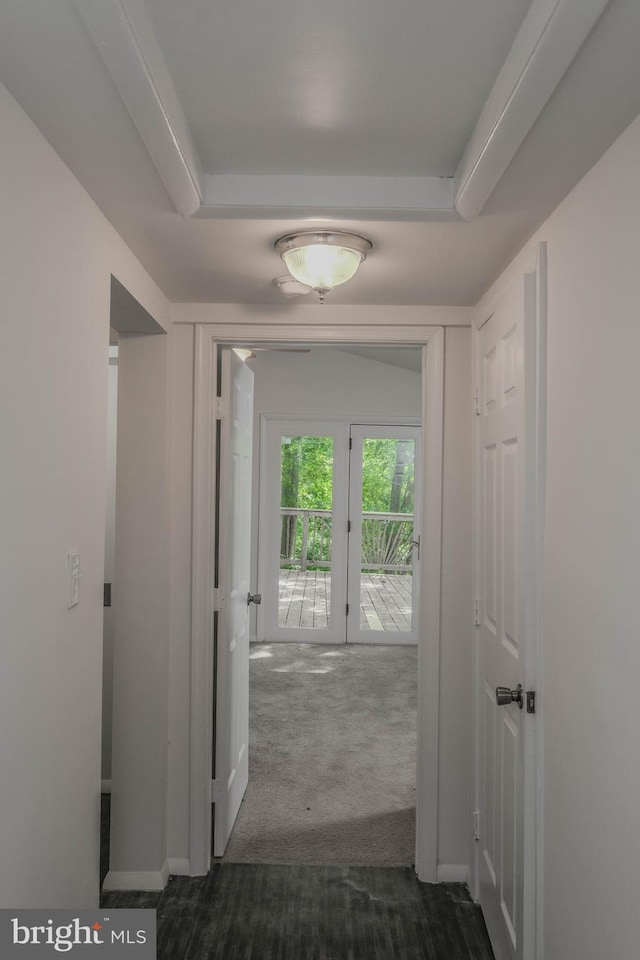 hall featuring dark colored carpet