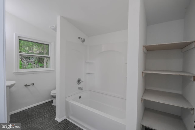 bathroom featuring shower / bath combination, toilet, and lofted ceiling