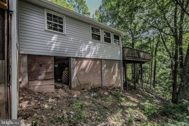 view of property exterior with a deck