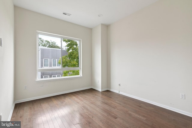 spare room with hardwood / wood-style floors