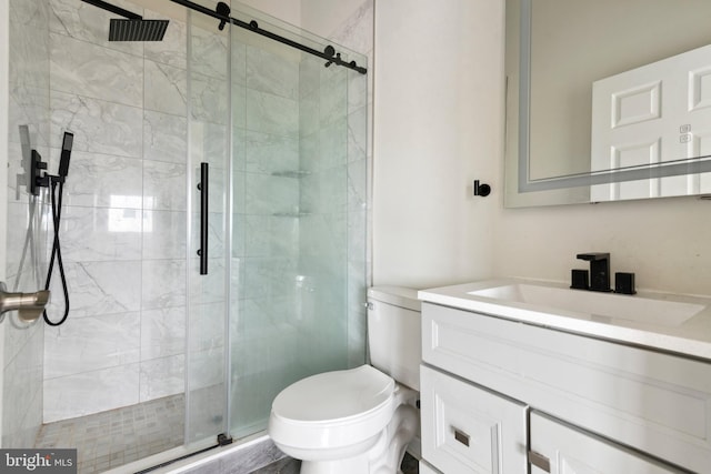 bathroom with toilet, vanity, and walk in shower