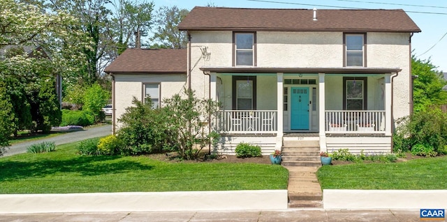 view of front of property with covered porch and a front lawn