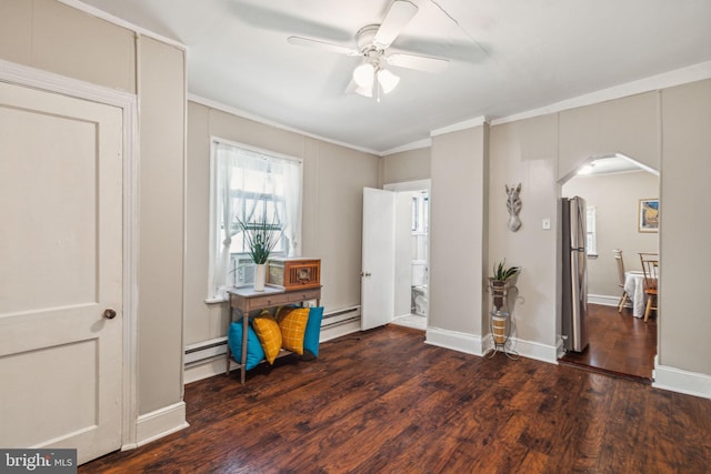 entrance foyer featuring dark hardwood / wood-style floors, baseboard heating, ceiling fan, and ornamental molding