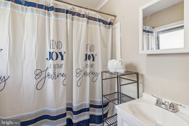 bathroom featuring curtained shower and vanity