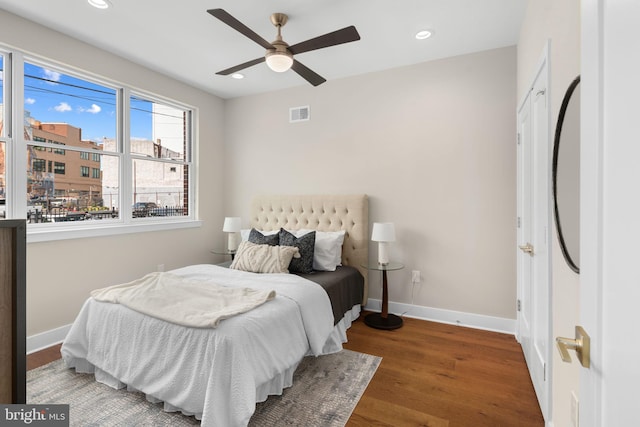 bedroom featuring ceiling fan and dark wood-type flooring