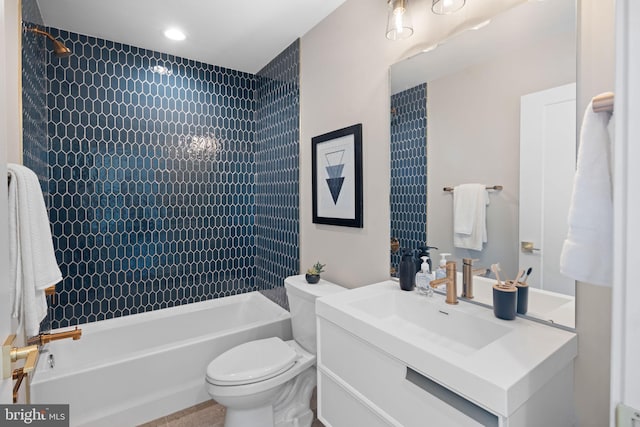 full bathroom featuring vanity, toilet, and tiled shower / bath