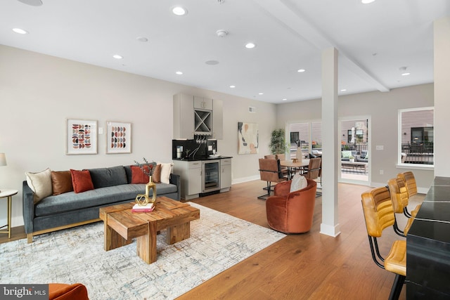 living room with light hardwood / wood-style flooring and beverage cooler