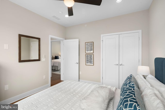 bedroom with ceiling fan, a closet, and hardwood / wood-style floors