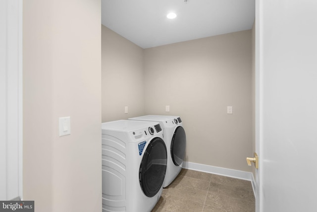 clothes washing area featuring separate washer and dryer