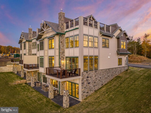 exterior space featuring a lawn and a balcony