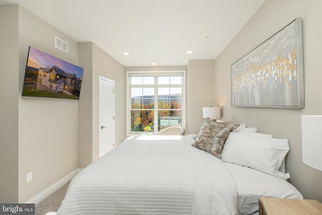 carpeted bedroom with recessed lighting, visible vents, and baseboards