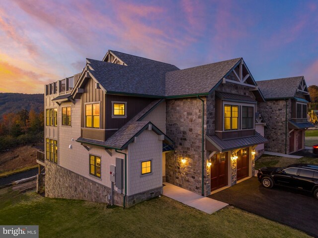 view of front of home featuring a garage and a yard