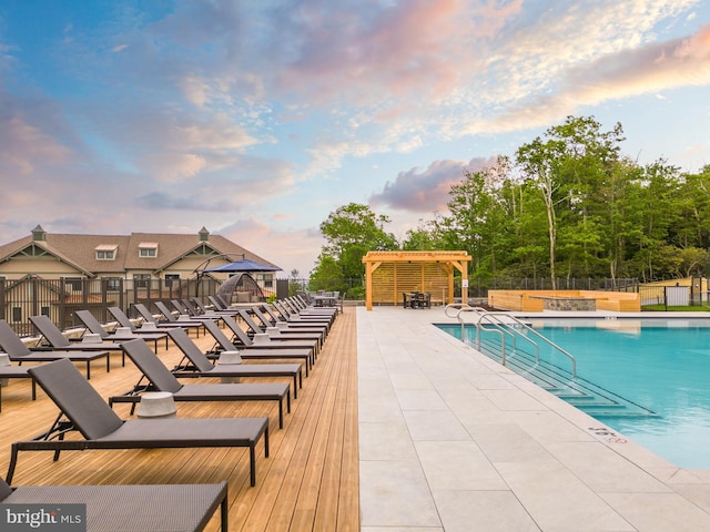 pool at dusk with a patio