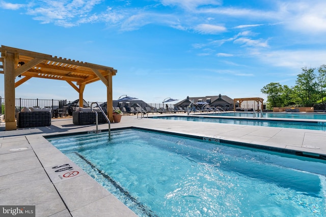 view of pool with a pergola and a patio