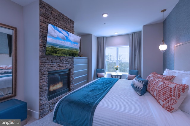 bedroom featuring carpet flooring and a fireplace