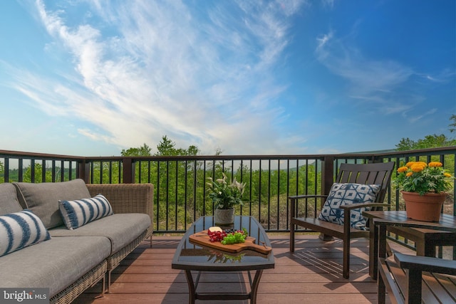 wooden deck with an outdoor living space