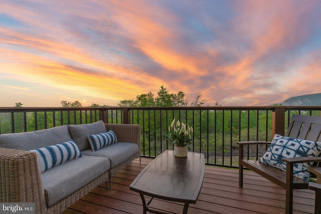 deck at dusk featuring an outdoor living space