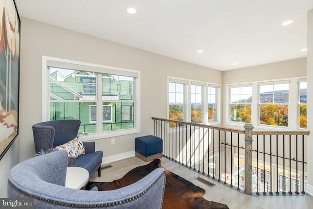 interior space featuring visible vents, baseboards, wood finished floors, and recessed lighting