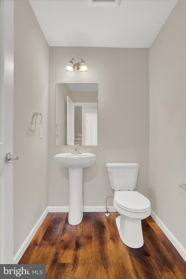 bathroom with sink, hardwood / wood-style flooring, and toilet