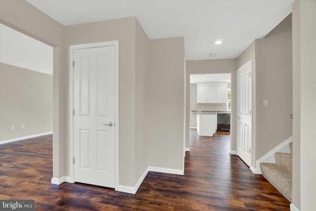 hallway with dark hardwood / wood-style floors