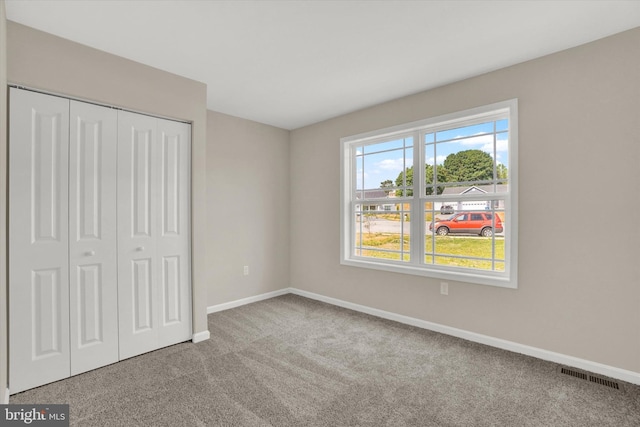 unfurnished bedroom featuring a closet and carpet