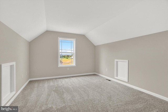 bonus room featuring vaulted ceiling and carpet flooring