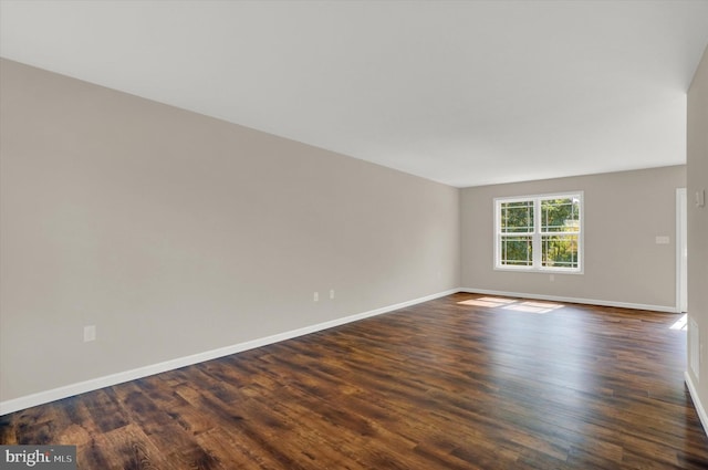 spare room featuring dark hardwood / wood-style flooring