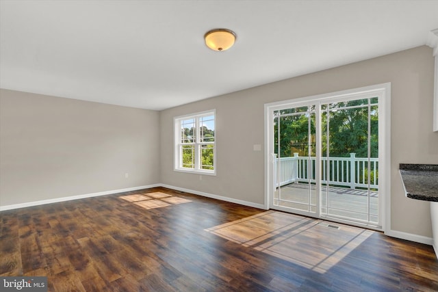 empty room with dark wood-type flooring